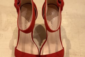 striking red suede sandals with a scalloped design and delicate ankle straps