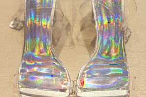 iridescent slide heels with a holographic finish and a clear strap
