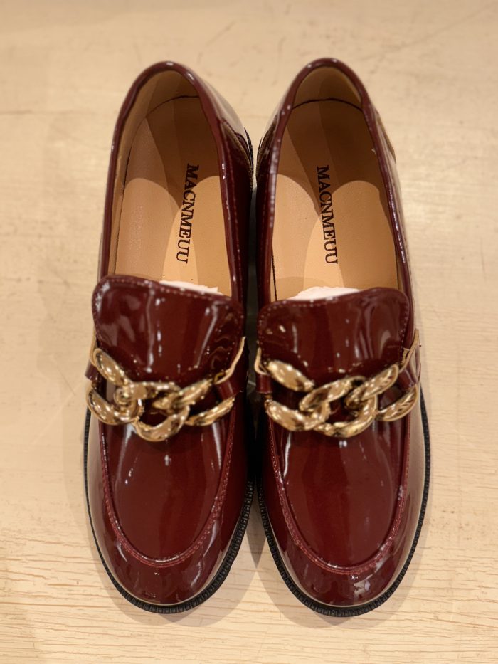 Glossy burgundy loafers with a braided gold chain embellishment.